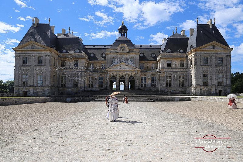 Costumed people in front of the Chateau de Vaux-le-Vicomte, France