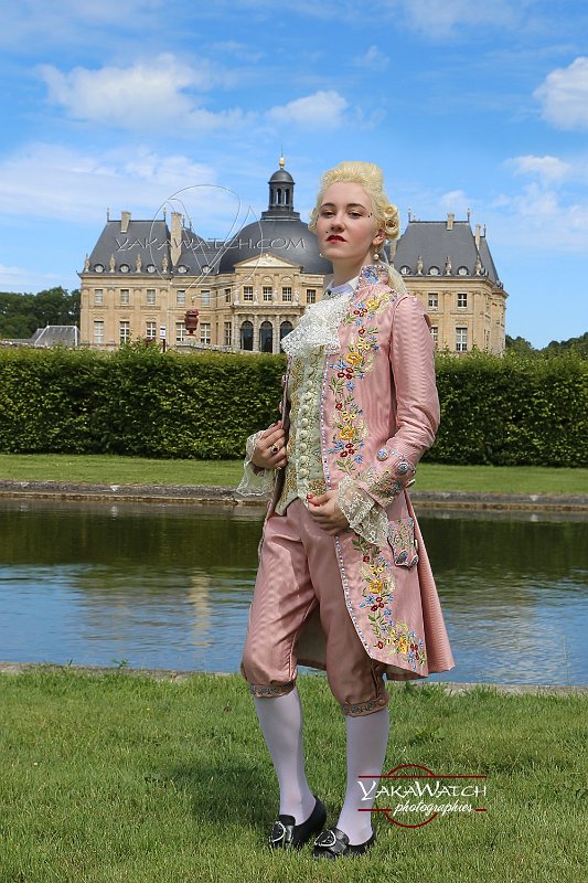 Young lady with man suit 'Chevalier d'Éon' in front of the chateau de Vaux-le-Vicomte